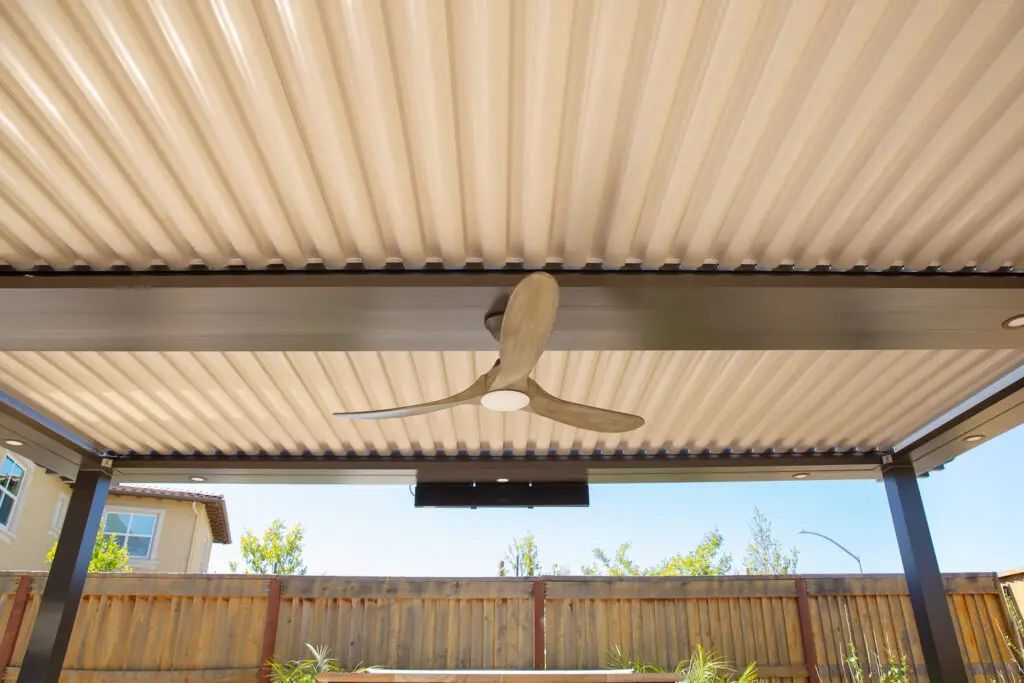 Underside of a louvered StruXure pergola roof with a ceiling fan and heater in Danville, CA