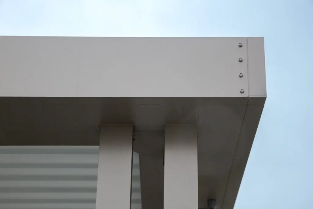 Close-up of a StruXure pergola beam corner against a cloudy sky in Emerald Hills, CA