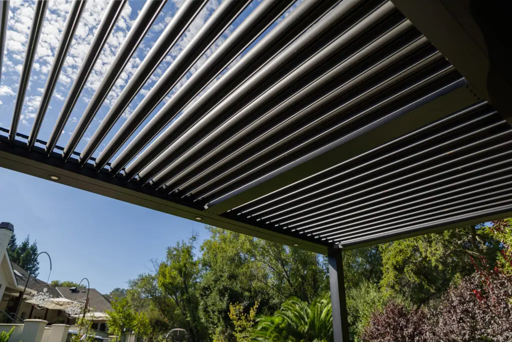 View looking up through open louvers of a StruXure pergola with recessed lighting in Saratoga, CA