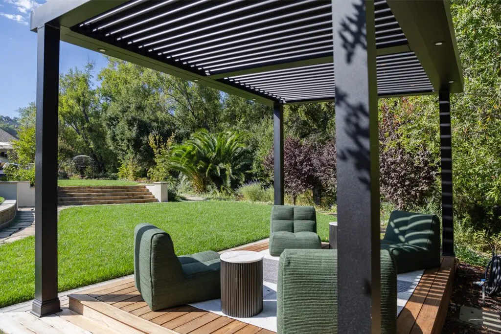 Wide view of a StruXure pergola with lounge seating and terraced landscaping in Saratoga, CA