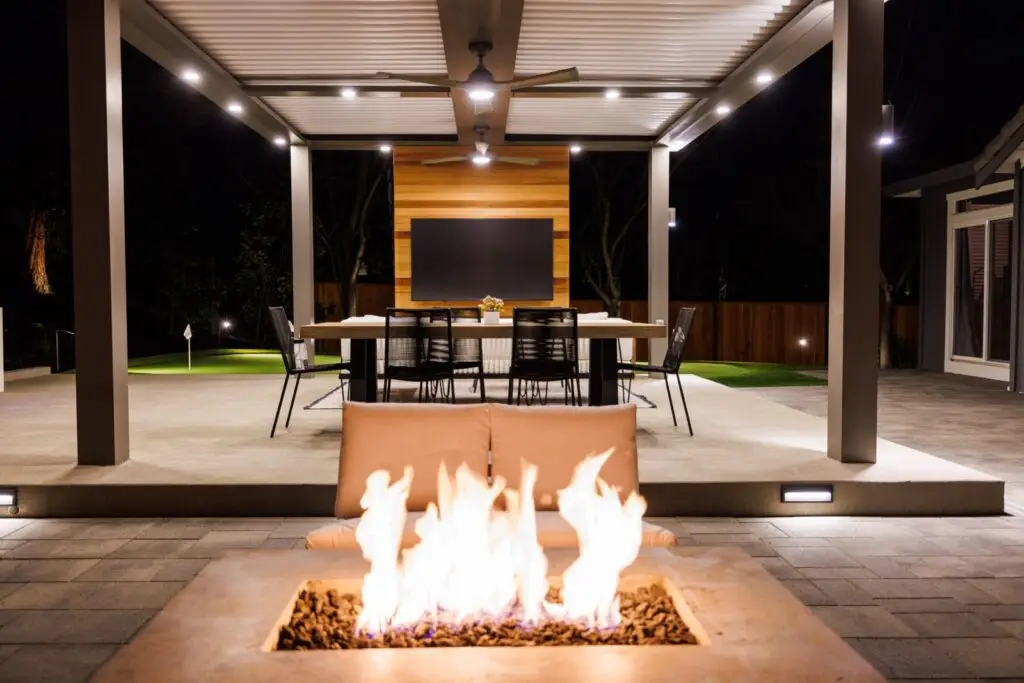 Fire pit and lounge seating under a StruXure pergola with dining beyond in Walnut Creek, CA