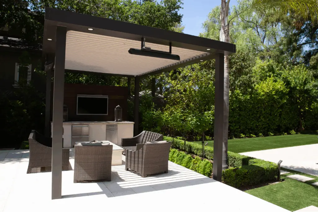 Pergola over lounge chairs and an outdoor kitchen